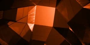 A faceted geometric form lit from one side.