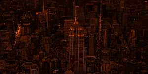 A city skyline at night, lit from within.